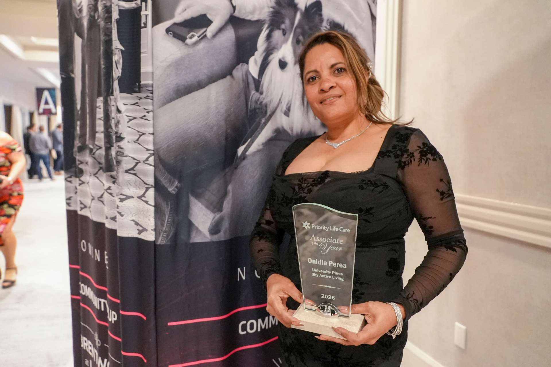 Associate of the year winner standing with her award